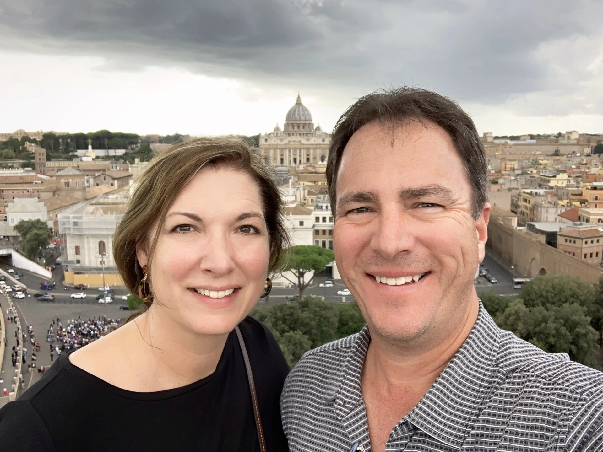 A selfie of Chandler and Jennifer in front of a background of a city
